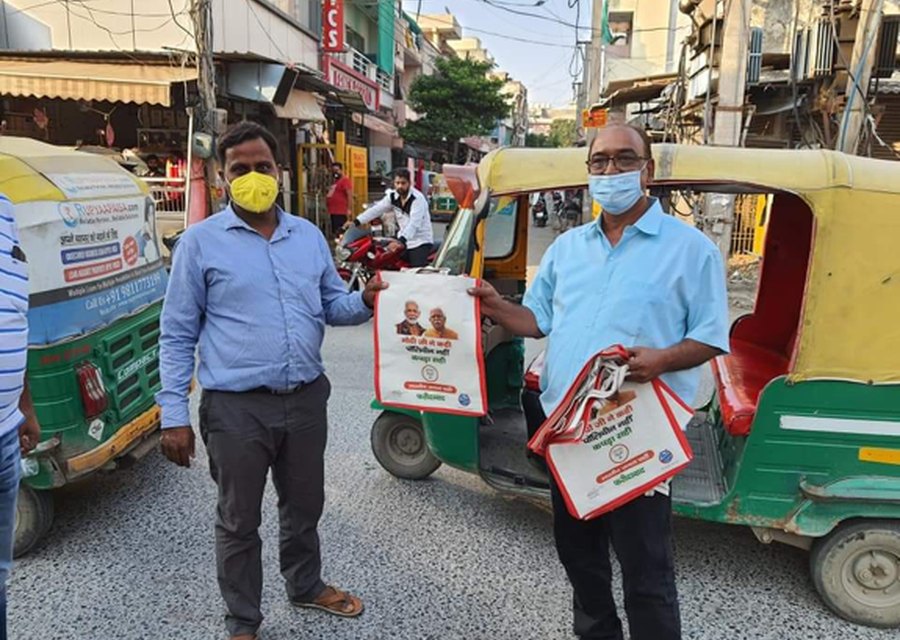 Reusable bags being distributed to auto-rickshaw drivers